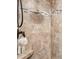 Tiled shower with built-in shelf and bronze fixtures, offering a luxurious showering experience at 107 Pressley St, Clover, SC 29710