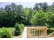 Relaxing backyard view from deck overlooking green lawn, mature trees, and wood fence at 1110 Archer Farm Dr, Salisbury, NC 28144