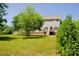A backyard view features a well-kept lawn, a two-story house with a walkout deck at 1110 Archer Farm Dr, Salisbury, NC 28144