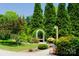 Lush backyard with an inviting garden bench nestled among mature trees and greenery at 1110 Archer Farm Dr, Salisbury, NC 28144