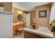 An expansive bathroom featuring a double vanity and a soaking tub next to a frosted glass window at 1110 Archer Farm Dr, Salisbury, NC 28144