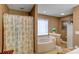 Bathroom features a tub, a floral shower curtain and neutral-toned walls at 1110 Archer Farm Dr, Salisbury, NC 28144