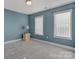A simple, cozy bedroom with blue walls, carpet flooring and two windows for plenty of natural light at 1110 Archer Farm Dr, Salisbury, NC 28144