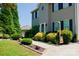 Charming two-story home featuring a manicured lawn, lush landscaping, and a welcoming entrance at 1110 Archer Farm Dr, Salisbury, NC 28144