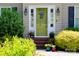 Inviting front entrance with decorated green door, sidelights, and well-maintained landscaping at 1110 Archer Farm Dr, Salisbury, NC 28144