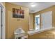 Upstairs hallway featuring art, a small table, and access to a bedroom, creating a welcoming transition space at 1110 Archer Farm Dr, Salisbury, NC 28144
