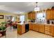 Bright kitchen featuring wood cabinets, neutral countertops, tile floors and eat-in bar at 1110 Archer Farm Dr, Salisbury, NC 28144