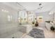 Bright bathroom featuring a tiled shower, a tub, a large rug, and a vanity at 1111 Thessallian Ln, Indian Trail, NC 28079