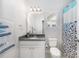 Bathroom showcasing a granite countertop, white cabinetry, a window, and a fish-themed shower curtain at 1111 Thessallian Ln, Indian Trail, NC 28079