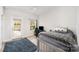 Bright bedroom featuring a twin bed, neutral walls, ceiling fan, and a glass door leading to outdoor space at 1111 Thessallian Ln, Indian Trail, NC 28079