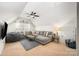 Bright bonus room featuring a cozy sectional, bean bag chair, and a ceiling fan at 1111 Thessallian Ln, Indian Trail, NC 28079