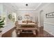Elegant dining room featuring wood table, bench seating, and stylish decor at 1111 Thessallian Ln, Indian Trail, NC 28079