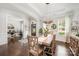 Bright dining room with modern light fixture, dark hardwood floors, and adjacent office space at 1111 Thessallian Ln, Indian Trail, NC 28079