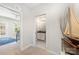 Hallway view showcasing a guest bathroom and a bedroom with a twin bed and natural light at 1111 Thessallian Ln, Indian Trail, NC 28079
