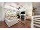 Bright living room features a coffered ceiling, hardwood floors, fireplace and large windows at 1111 Thessallian Ln, Indian Trail, NC 28079