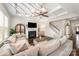 Cozy living room features a fireplace, ceiling fan, and staircase to the upper level at 1111 Thessallian Ln, Indian Trail, NC 28079