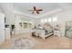 Tranquil main bedroom featuring tray ceilings, a ceiling fan, and bright natural light at 1111 Thessallian Ln, Indian Trail, NC 28079