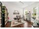 Well-lit home office with a modern desk, built-in shelves, and a large window at 1111 Thessallian Ln, Indian Trail, NC 28079