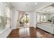 Sun-drenched sun room with hardwood floors, large windows, and sliding door to the patio at 1111 Thessallian Ln, Indian Trail, NC 28079