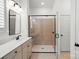 Modern bathroom with a glass enclosed shower and white vanity at 1318 Encore Ln, Waxhaw, NC 28173