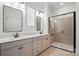 Bathroom featuring double vanities, modern fixtures, and glass enclosed shower at 1318 Encore Ln, Waxhaw, NC 28173