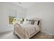 Bright bedroom featuring a cozy bed, large windows, and neutral décor at 1318 Encore Ln, Waxhaw, NC 28173