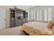 Bedroom with a built-in entertainment center and lots of natural light at 1318 Encore Ln, Waxhaw, NC 28173