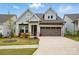 Charming home with a two car garage, beautiful landscaping, and a welcoming front porch at 1318 Encore Ln, Waxhaw, NC 28173