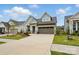 Home with an inviting, well-manicured lawn, complementing the light blue siding and earth-toned driveway at 1318 Encore Ln, Waxhaw, NC 28173