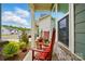 Inviting front porch featuring comfortable rocking chairs and vibrant landscaping at 1318 Encore Ln, Waxhaw, NC 28173