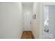 Bright hallway with wood floors, white walls, and natural light streaming in at 1318 Encore Ln, Waxhaw, NC 28173