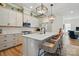 Open-concept kitchen with an island, modern appliances, and bar stool seating at 1318 Encore Ln, Waxhaw, NC 28173