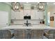 Open kitchen featuring a large island with seating, quartz countertops, and modern pendant lighting at 1318 Encore Ln, Waxhaw, NC 28173