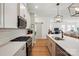 Well-equipped kitchen with sleek white cabinets, stainless steel appliances, quartz countertops, and stylish subway tile backsplash at 1318 Encore Ln, Waxhaw, NC 28173