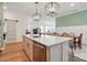 Bright kitchen featuring an island with quartz countertop, stainless steel appliances, and modern pendant lighting at 1318 Encore Ln, Waxhaw, NC 28173