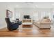 Bright living room with hardwood floors, comfortable seating, and a decorative rug at 1318 Encore Ln, Waxhaw, NC 28173