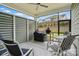 Relaxing screened porch featuring a ceiling fan, outdoor seating, and backyard view at 1318 Encore Ln, Waxhaw, NC 28173
