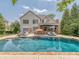 Large backyard with a pool, outdoor kitchen, and ample space for relaxation and entertaining at 1404 Lookout Cir, Waxhaw, NC 28173