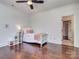 Cozy bedroom featuring hardwood floors, a ceiling fan, and a white bed frame at 1404 Lookout Cir, Waxhaw, NC 28173