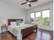 Bedroom with hardwood floors, ceiling fan, and a large window with a view at 1404 Lookout Cir, Waxhaw, NC 28173