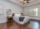 Comfortable bedroom with hardwood floors, tray ceilings, and shuttered windows at 1404 Lookout Cir, Waxhaw, NC 28173