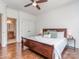 Bedroom featuring hardwood floors, a ceiling fan, and an ensuite bathroom at 1404 Lookout Cir, Waxhaw, NC 28173