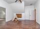 Bonus room featuring hardwood floors, a play area, and an attic window at 1404 Lookout Cir, Waxhaw, NC 28173