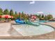 Fun community pool area featuring a splash pad, slides, and ample seating for families at 1404 Lookout Cir, Waxhaw, NC 28173