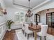 Bright dining room with a wood table, elegant chairs, plantation shutters, and stylish decor at 1404 Lookout Cir, Waxhaw, NC 28173