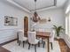 Elegant dining room featuring a wood table, upholstered chairs, and an ornate chandelier at 1404 Lookout Cir, Waxhaw, NC 28173