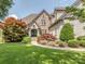 Inviting stone-accented home with lush landscaping and a curved walkway leading to the elegant arched front door at 1404 Lookout Cir, Waxhaw, NC 28173