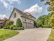 Attached garage with two parking spaces, a large driveway and well-maintained landscaping at 1404 Lookout Cir, Waxhaw, NC 28173