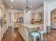 Spacious kitchen featuring a large island, custom cabinetry, and hardwood floors at 1404 Lookout Cir, Waxhaw, NC 28173
