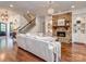 Spacious living room with stone fireplace, hardwood floors, and staircase access at 1404 Lookout Cir, Waxhaw, NC 28173